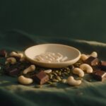 Can You Take Zinc and Magnesium Together? ZMA Explained Pumpkin seeds, cashews and dark chocolate around a dish of zinc and magnesium capsules