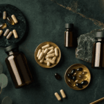 Best Zinc Supplement 2026: Picolinate vs Bisglycinate vs Gluconate Ranked Premium supplement capsules and amber bottles on a forest-green surface